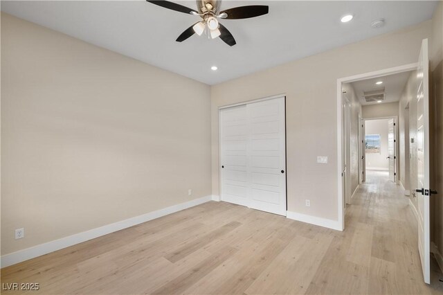 unfurnished bedroom with light hardwood / wood-style floors, a closet, and ceiling fan