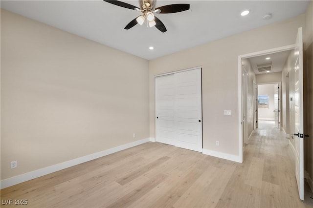 unfurnished bedroom featuring a closet, ceiling fan, and light wood-type flooring