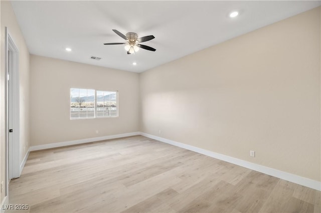 spare room featuring ceiling fan and light hardwood / wood-style flooring