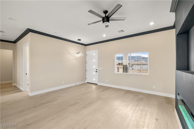 unfurnished living room with crown molding, ceiling fan, and light wood-type flooring