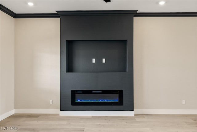 interior details featuring a fireplace, ornamental molding, and wood-type flooring