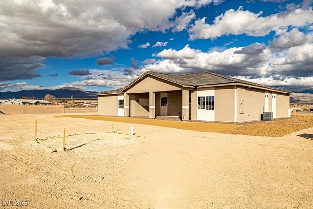 view of front of house featuring a mountain view and central air condition unit