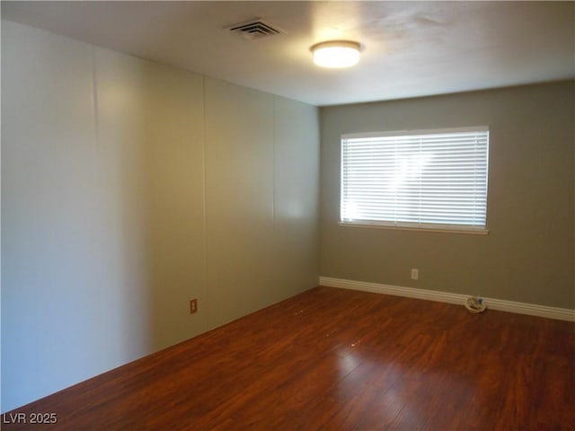 unfurnished room with dark hardwood / wood-style flooring