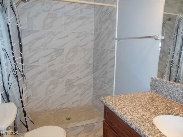 bathroom featuring walk in shower, vanity, and toilet