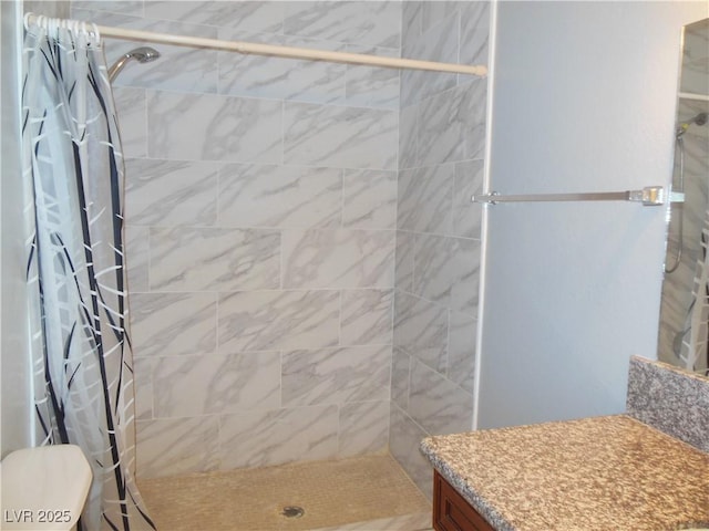 bathroom with toilet and a shower with curtain