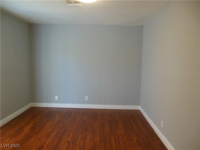 unfurnished room with dark hardwood / wood-style floors