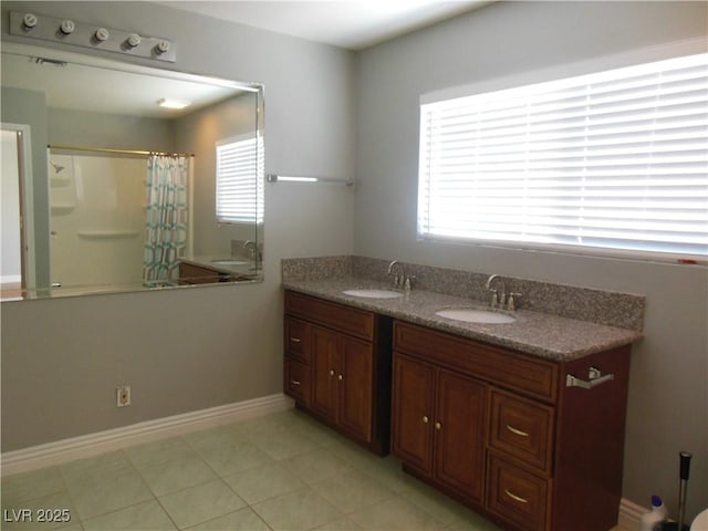 bathroom with vanity, a healthy amount of sunlight, curtained shower, and tile patterned floors