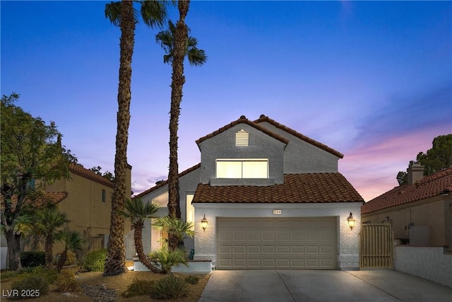 mediterranean / spanish-style house with a garage