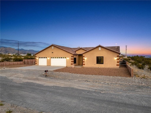 view of front facade featuring a garage and a mountain view