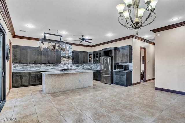 kitchen featuring light tile patterned flooring, ceiling fan with notable chandelier, stainless steel fridge with ice dispenser, and a center island with sink