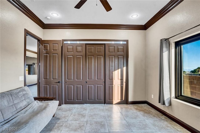 foyer with ornamental molding, light tile patterned floors, and ceiling fan