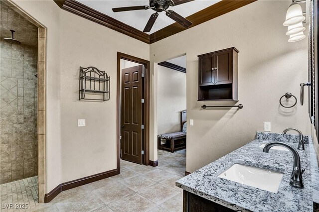 bathroom featuring a tile shower, tile patterned flooring, vanity, ceiling fan, and crown molding