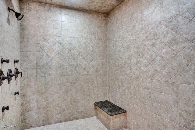 bathroom with a tile shower