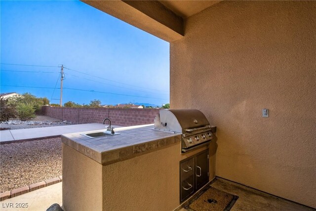 view of patio / terrace featuring exterior kitchen, area for grilling, and sink