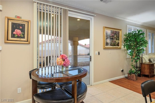 dining room featuring light tile patterned floors and baseboards