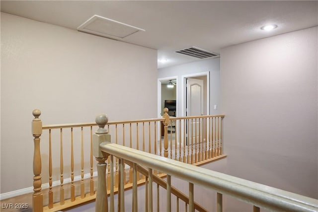 hallway with recessed lighting, an upstairs landing, baseboards, visible vents, and attic access