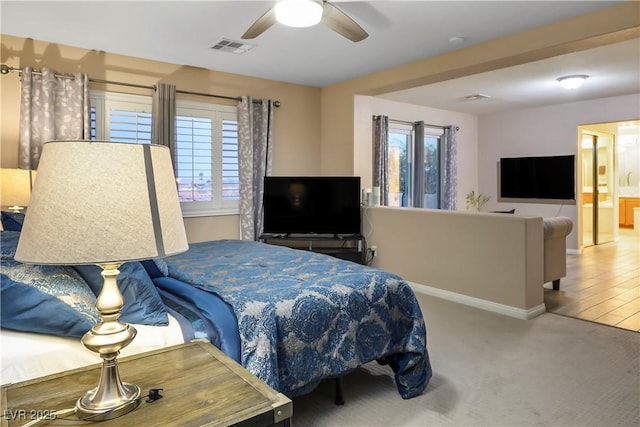 bedroom featuring ceiling fan, carpet floors, visible vents, and baseboards