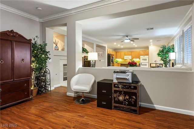 bar with stainless steel fridge, visible vents, white microwave, wood finished floors, and crown molding