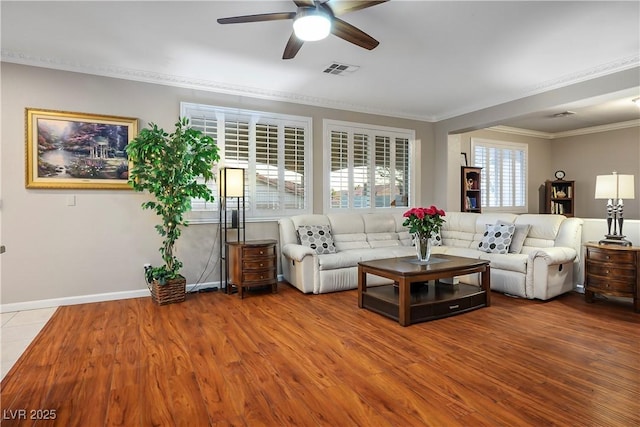 living room featuring ceiling fan, ornamental molding, and hardwood / wood-style floors