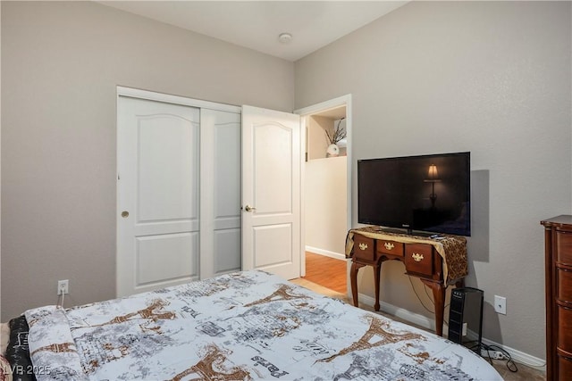 bedroom featuring a closet and baseboards