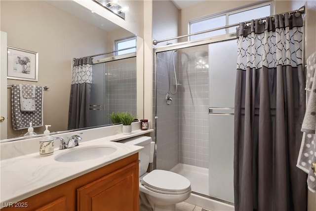 bathroom with walk in shower, plenty of natural light, toilet, and vanity