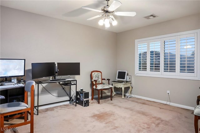 carpeted office space featuring ceiling fan, visible vents, and baseboards