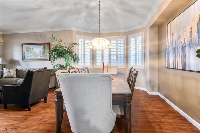 dining room with ornamental molding, dark wood-type flooring, and an inviting chandelier