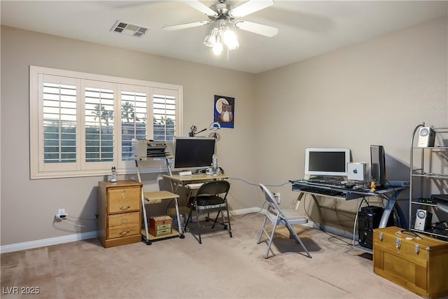 office space featuring carpet, visible vents, ceiling fan, and baseboards