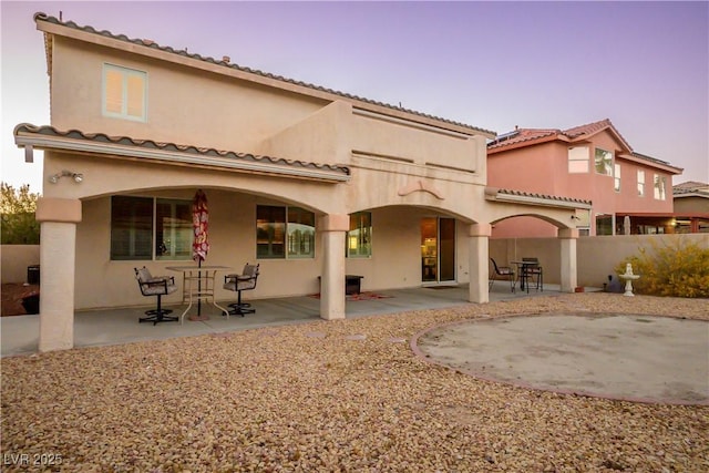 back of property featuring a patio area, fence, and stucco siding