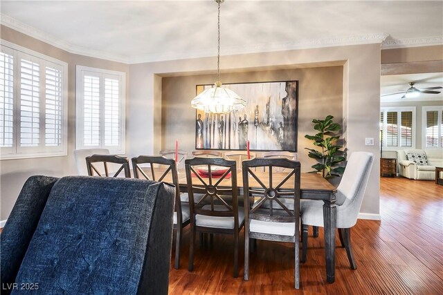 dining space with ceiling fan, ornamental molding, and wood-type flooring