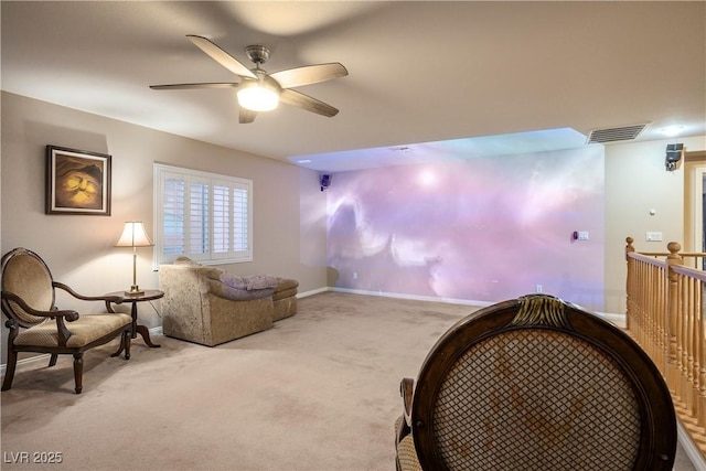 living area featuring ceiling fan, carpet flooring, visible vents, and baseboards