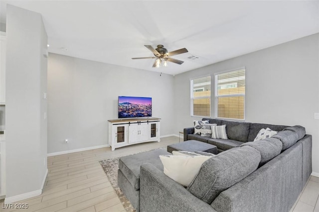 living room featuring light wood-type flooring and ceiling fan