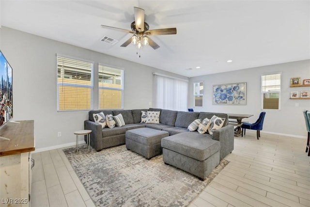 living room featuring ceiling fan and light wood-type flooring