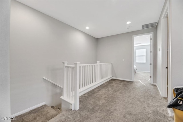 corridor with light colored carpet