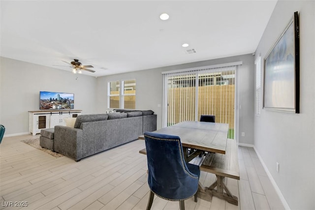 living room featuring ceiling fan and light hardwood / wood-style flooring