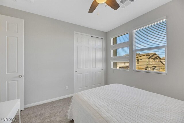 bedroom with light carpet, a closet, and ceiling fan