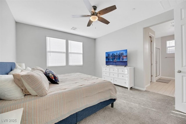 carpeted bedroom with multiple windows and ceiling fan