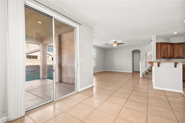 interior space with ceiling fan