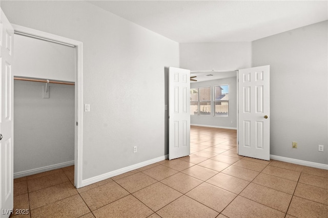 unfurnished bedroom featuring light tile patterned floors and a closet