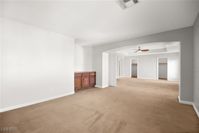 unfurnished living room with light carpet and ceiling fan