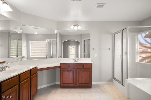 bathroom featuring vanity, a wealth of natural light, and plus walk in shower