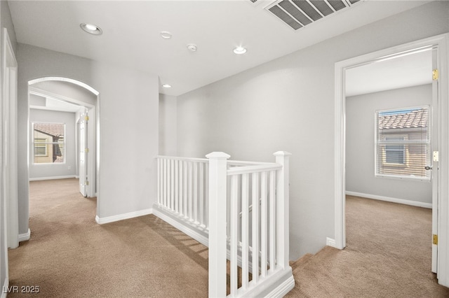 corridor with light colored carpet