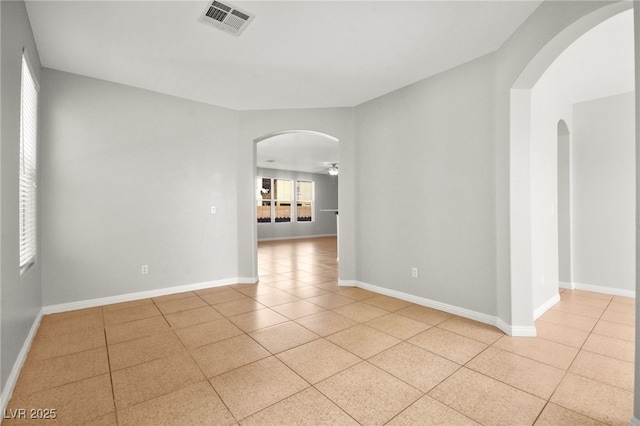 unfurnished room with light tile patterned floors and ceiling fan