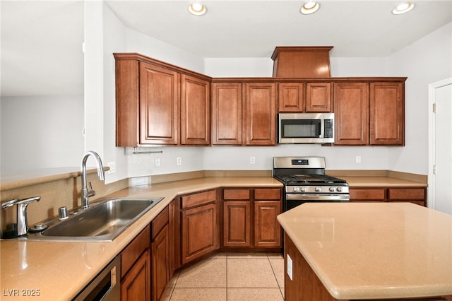 kitchen with sink, light tile patterned floors, and appliances with stainless steel finishes