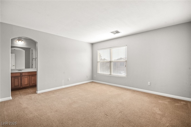 empty room featuring light colored carpet