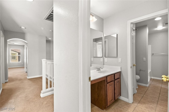 bathroom with vanity, tile patterned floors, and toilet