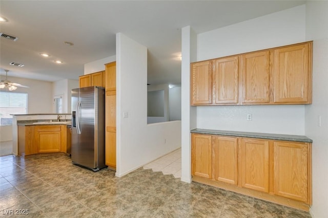 kitchen featuring sink, ceiling fan, and stainless steel fridge with ice dispenser