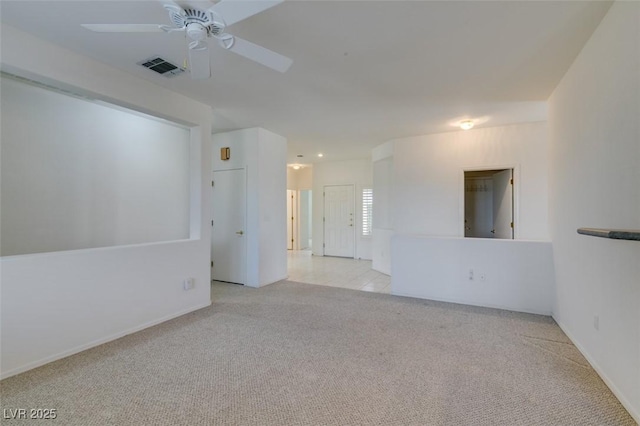 carpeted empty room featuring ceiling fan