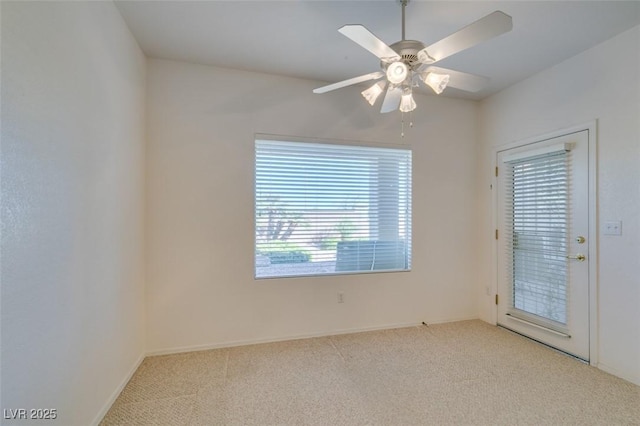 carpeted spare room featuring ceiling fan