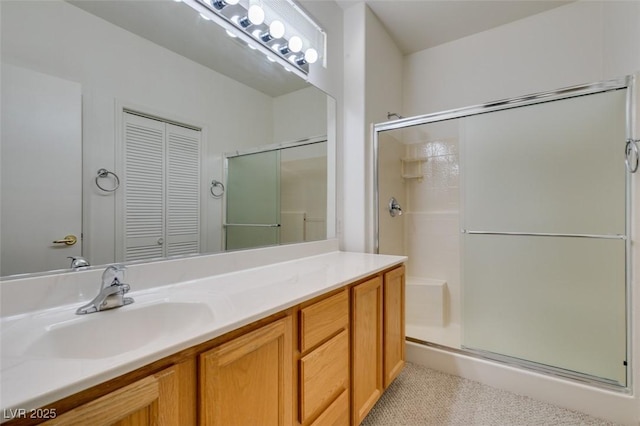 bathroom with walk in shower and vanity